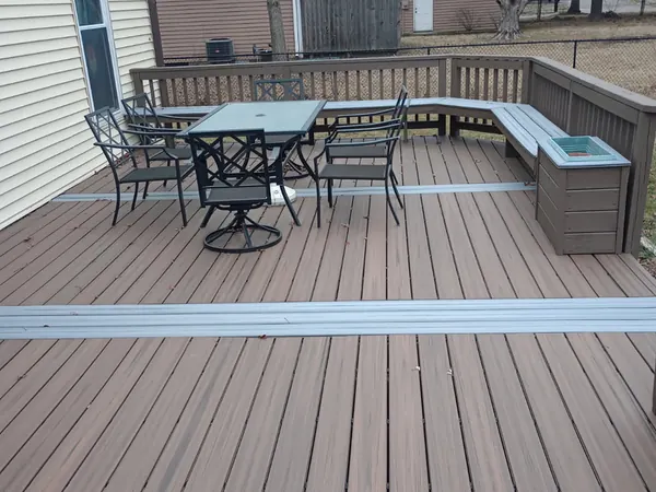 Composite deck with built-in seating and a patio table