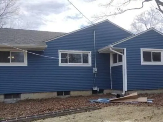 Ranch house in blue vinyl siding with white trim