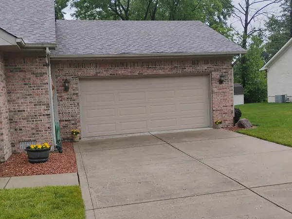 Brick ranch with a finished gray shingle roof and a two-car garage