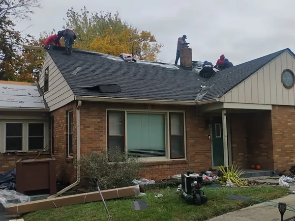 Roofing crew working on a brick ranch roof