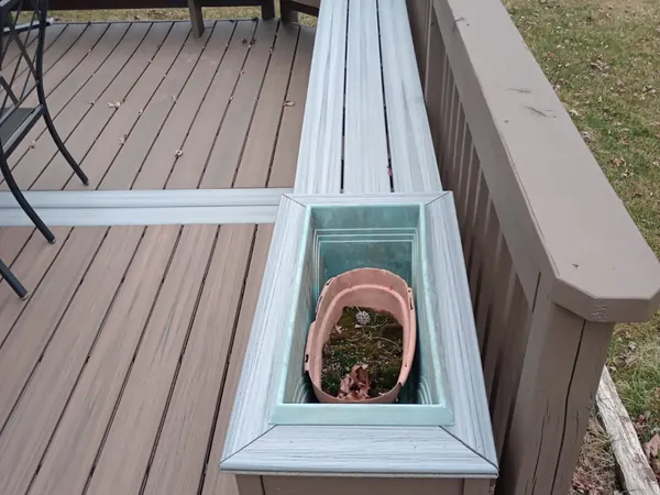 Composite deck with a built-in planter box and bench