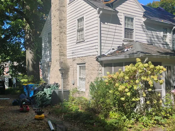 New plywood decking going onto a two-story roof