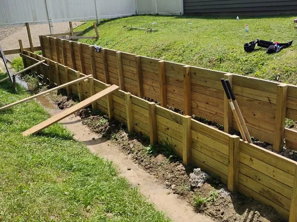 New timber retaining wall along a sloped yard