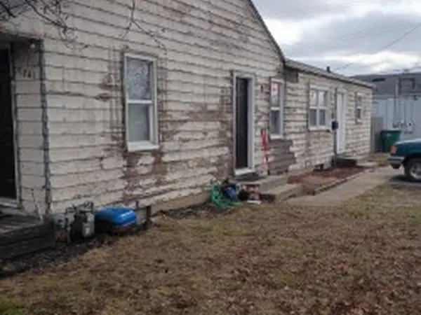 Ranch house with weathered, peeling siding